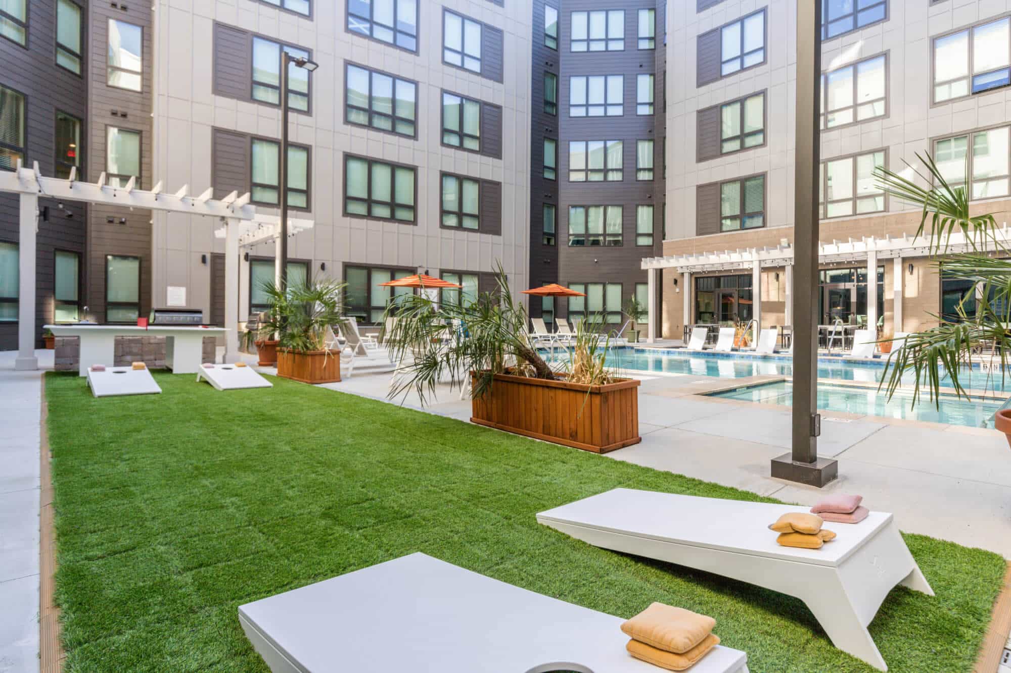 the nest at university center luxury off campus apartments near winthrop university resort style pool courtyard games cornhole boards and ping pong
